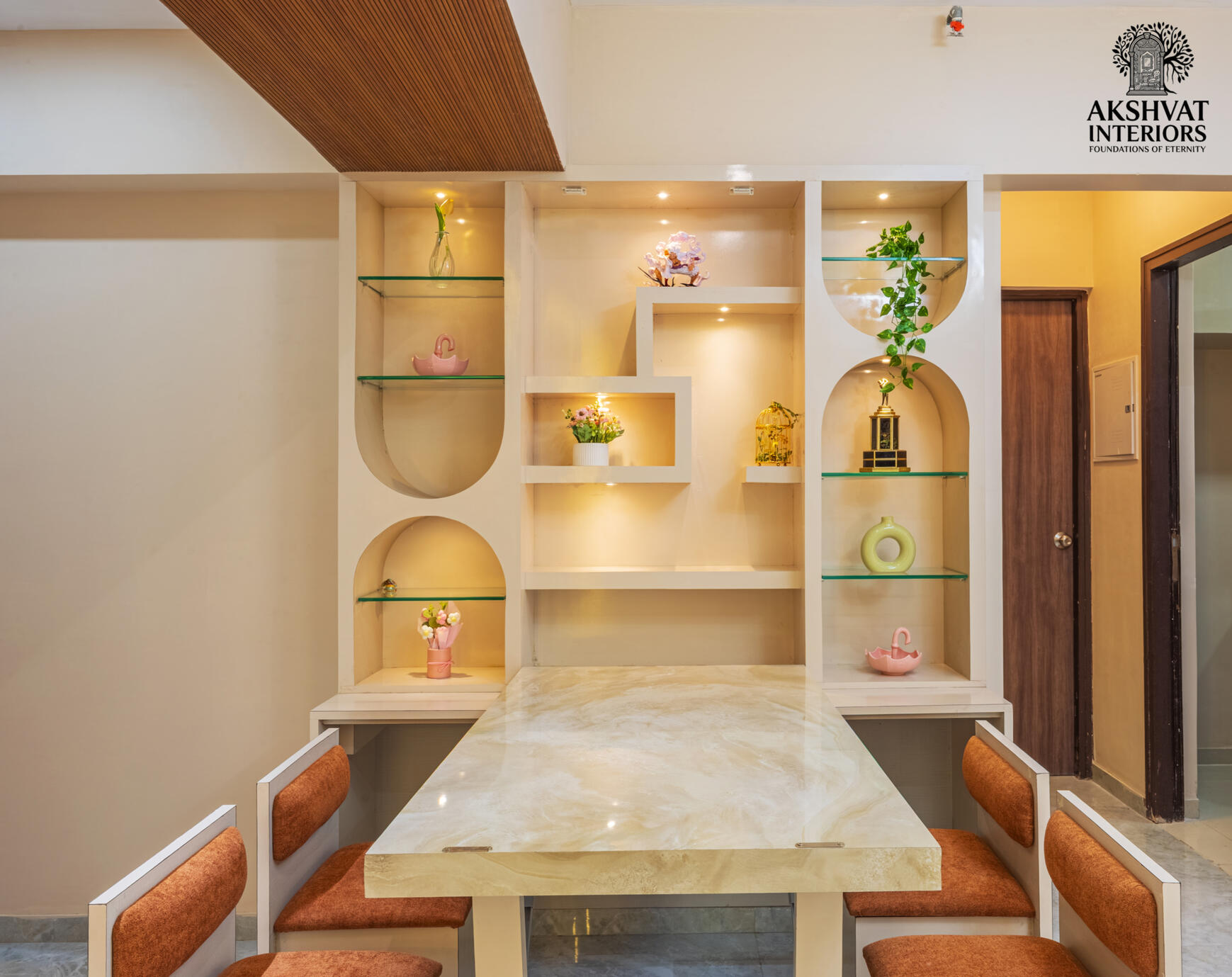 Modern interior photography of custom arched wall display niches with warm accent lighting by Akshvat Interiors.