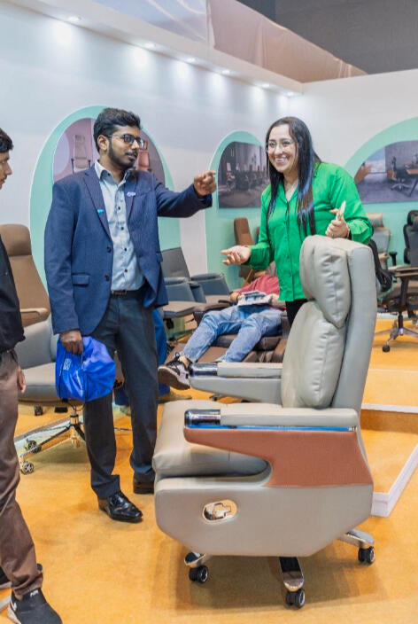 Professional candid photography capturing business interactions at a furniture exhibition in Mumbai.