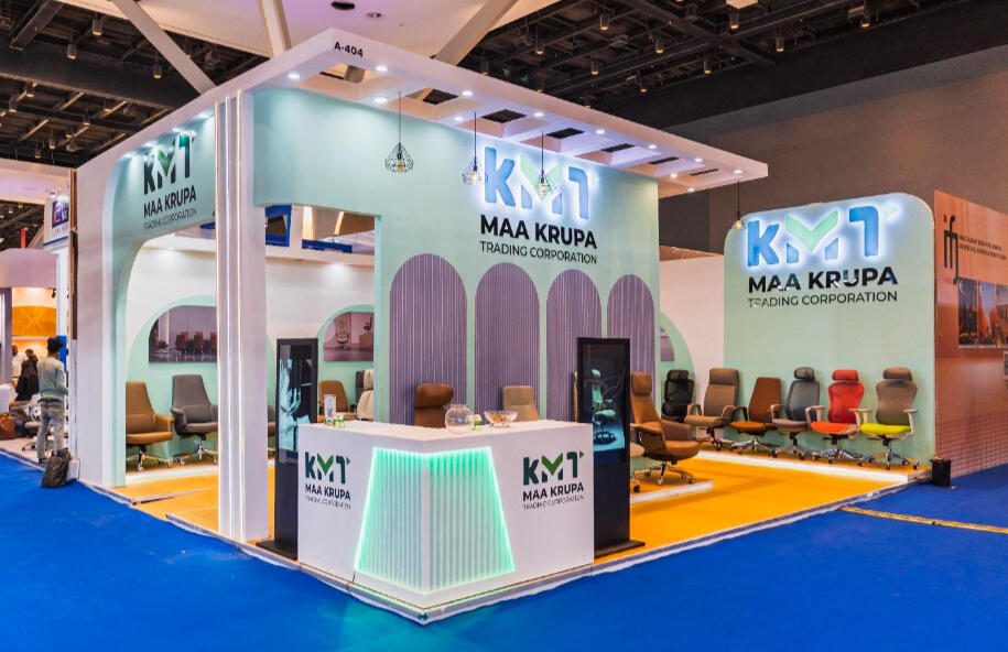 Professional wide shot of the Maa Krupa Trading Corporation exhibition booth showcasing office chairs.